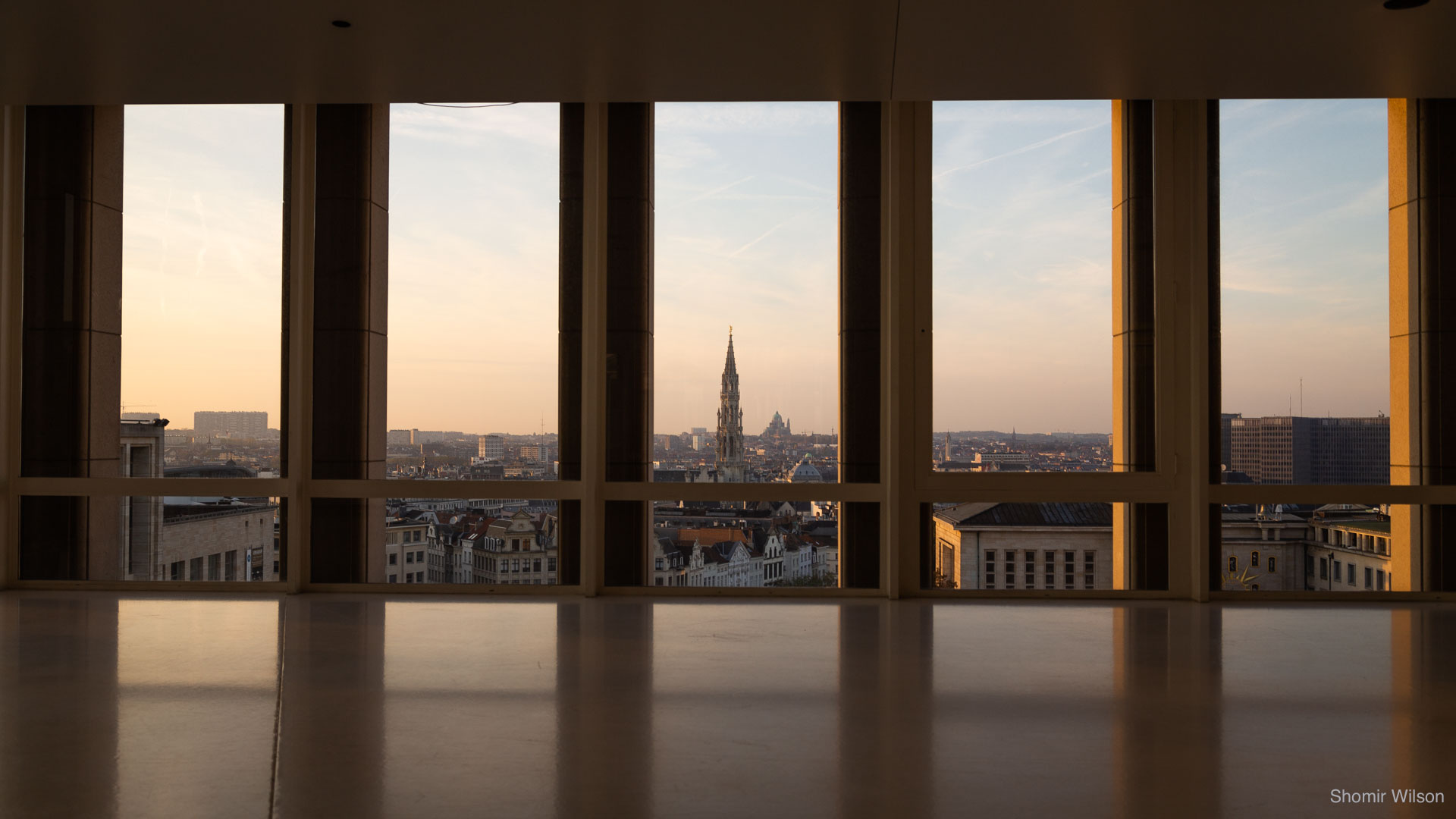 Brussels cityscape through tall windows