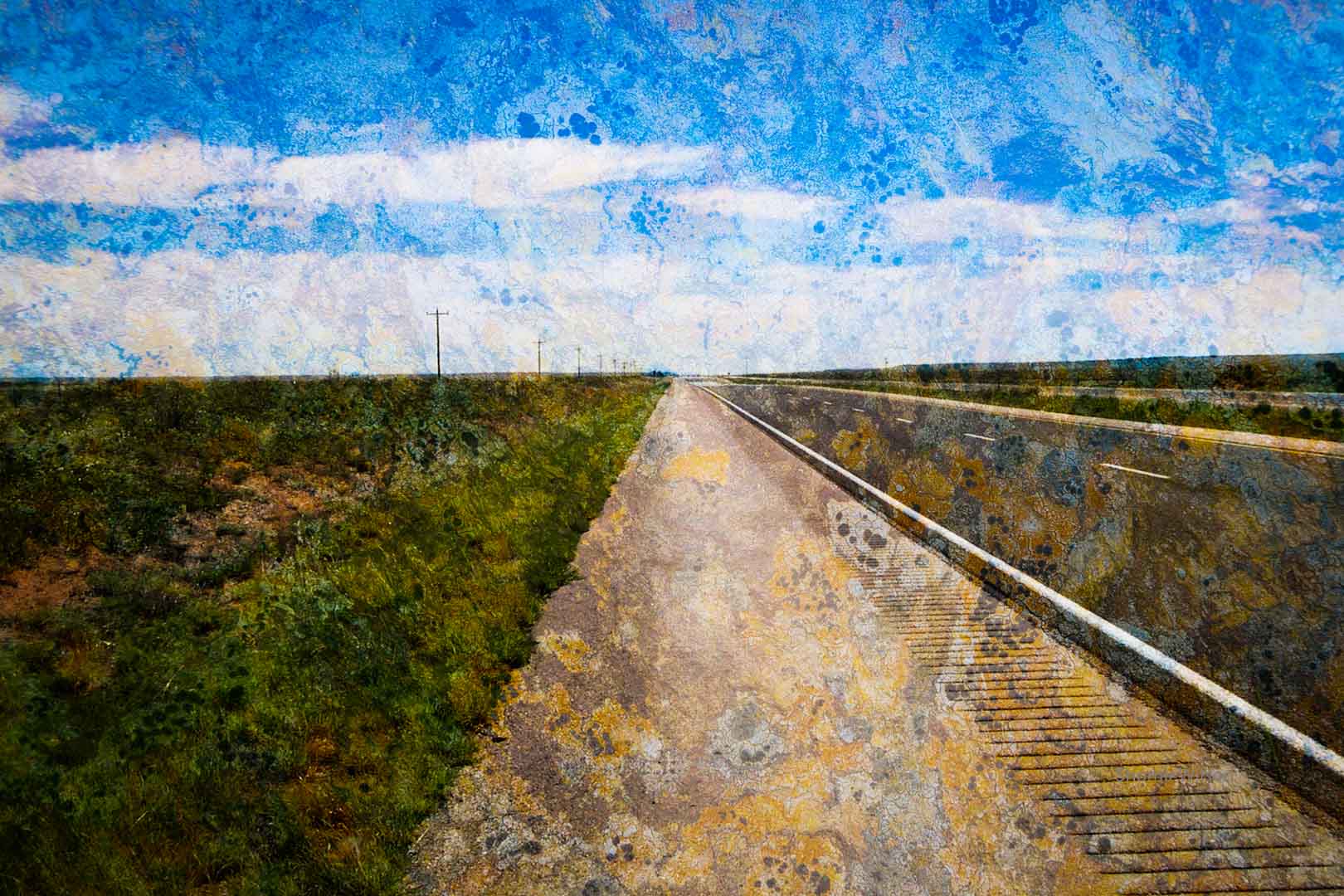 View along the shoulder of a highway in a semi-arid desert, with a crumpled texture overlay