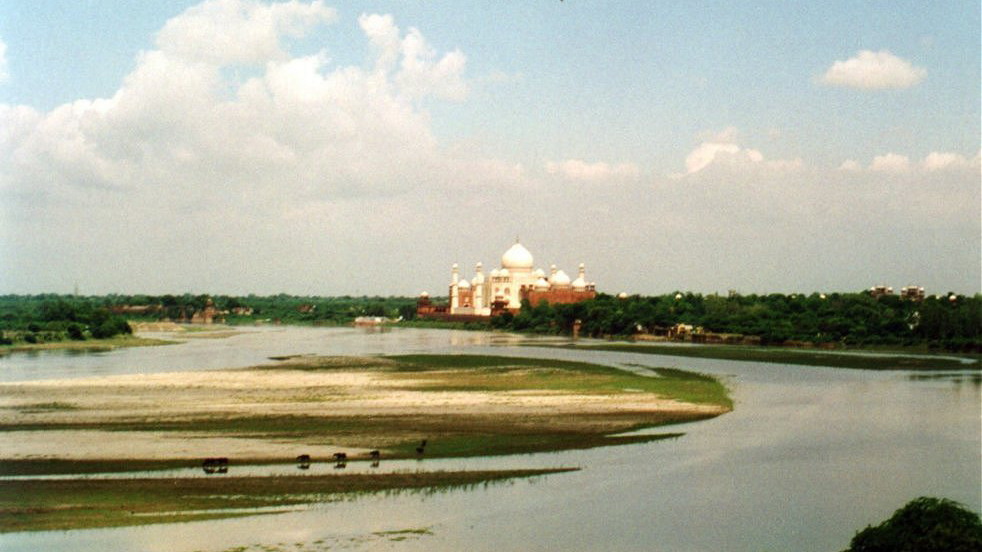 The Taj Mahal from across a wide sandy river