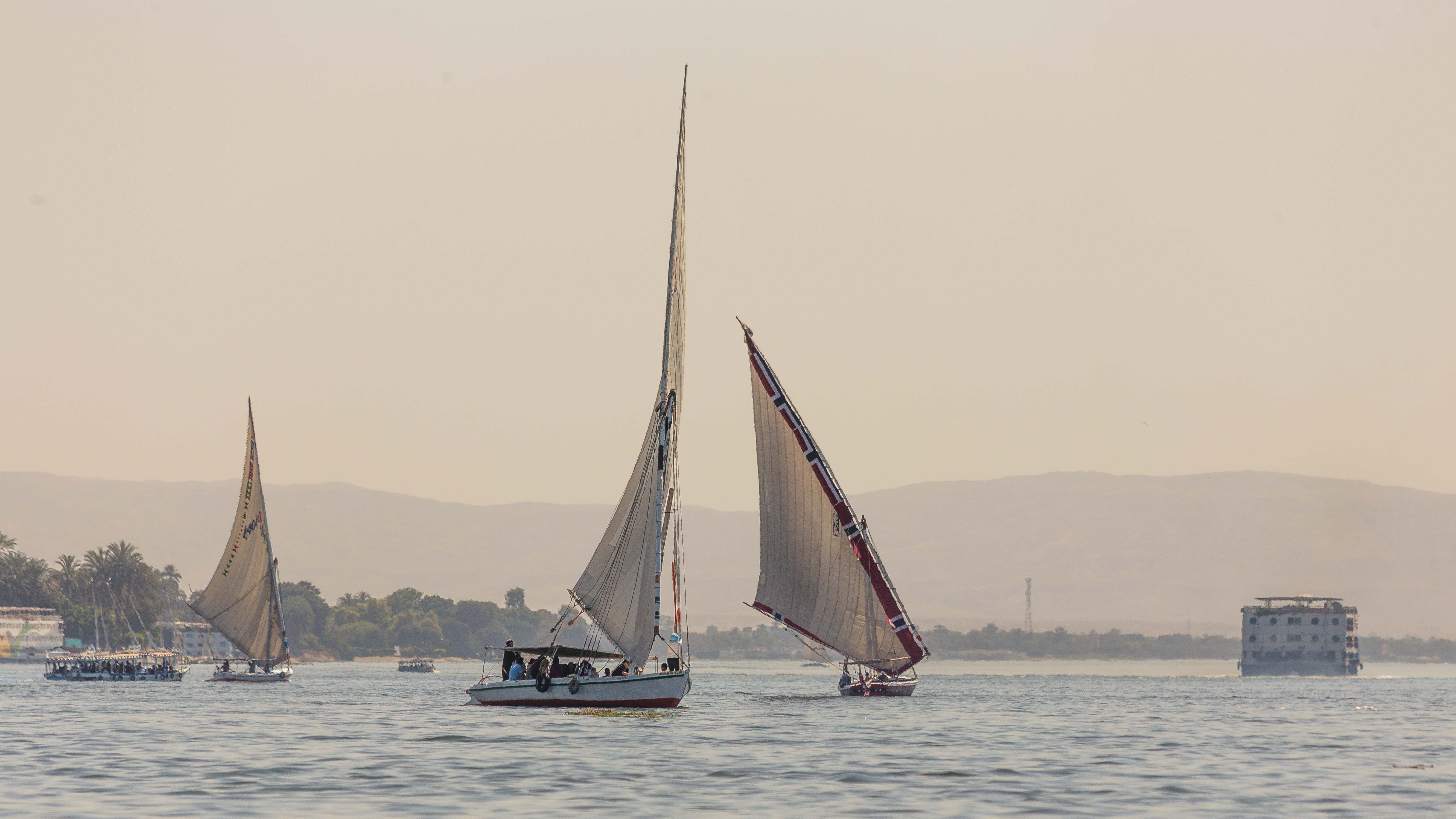 Sailboats on a river with a hazy sepia sky