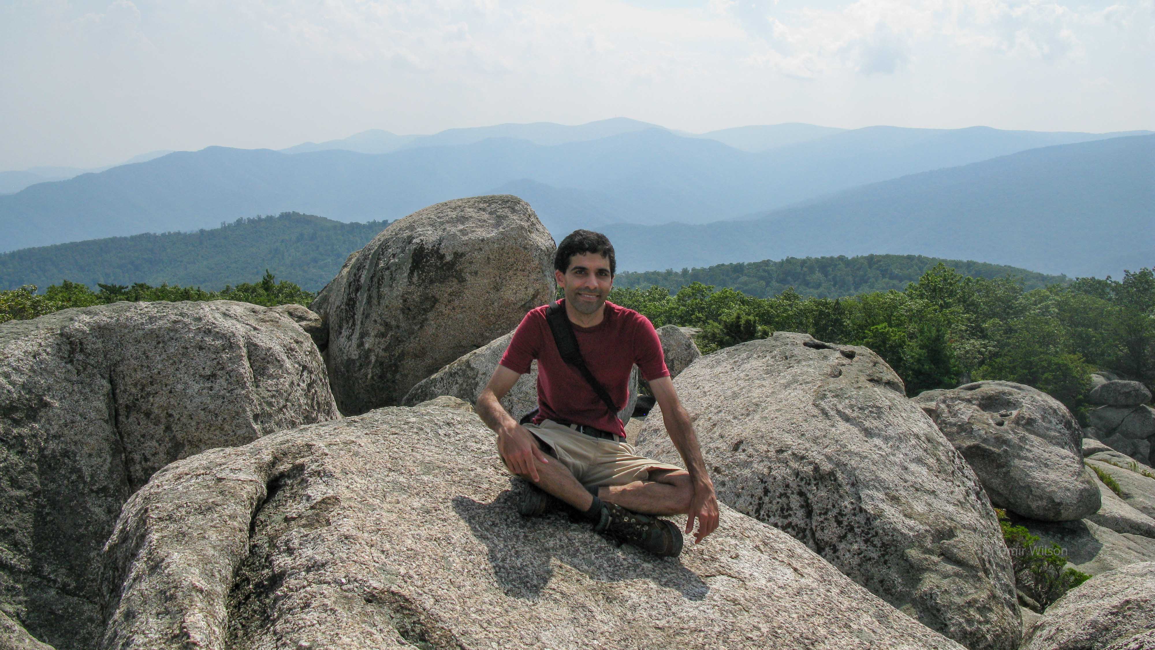 Me the summer after graduate school sitting atop giant boulders