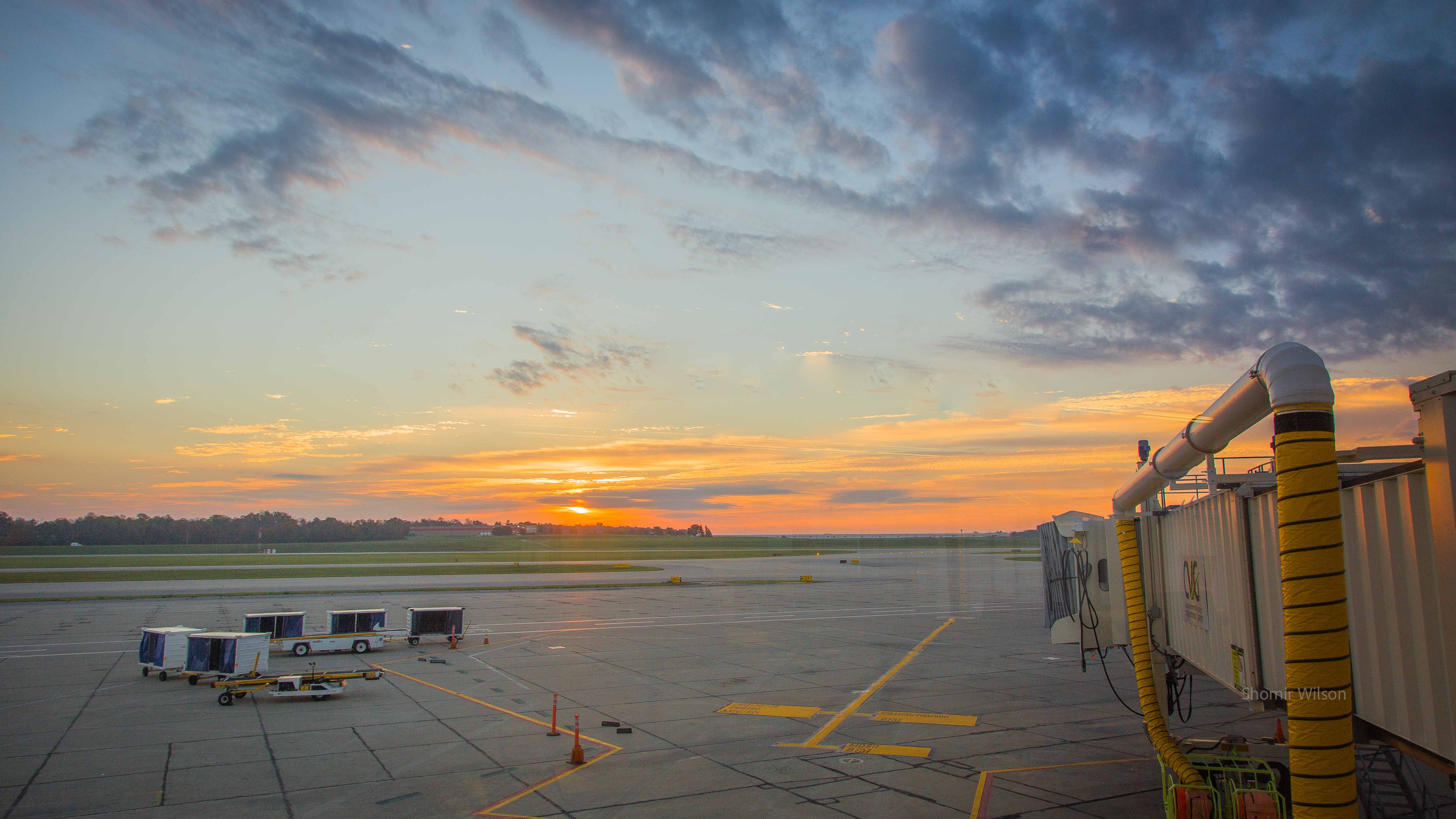 Orange and blue sky over an airport apron