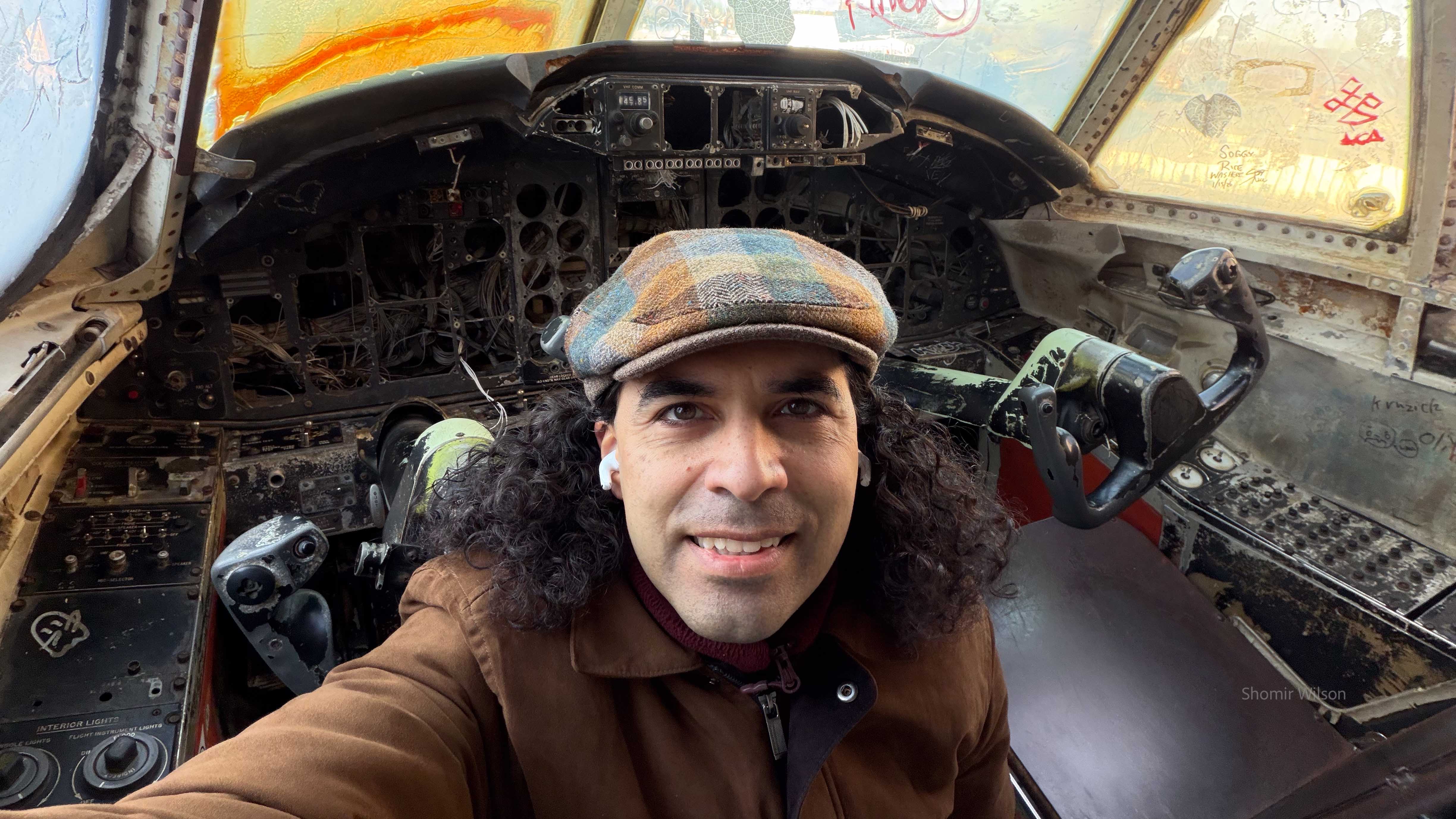 Me in the cockpit of a disused plane skeleton