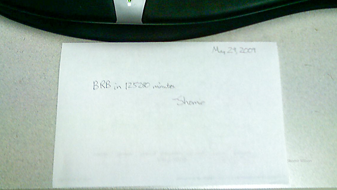 Blurry picture of a handwritten note in front of a keyboard: May 29, 2009, BRB in 125280 minutes &mdash;Shomir